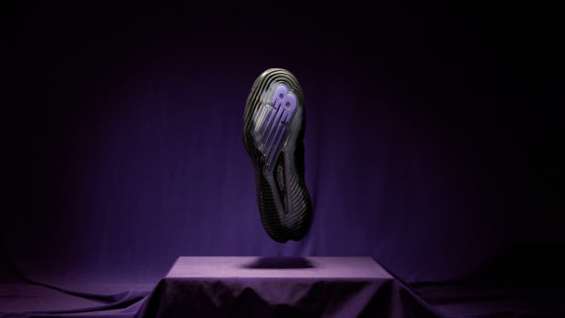 The outsole of Coco Gauff's black and purple New Balance tennis shoes.